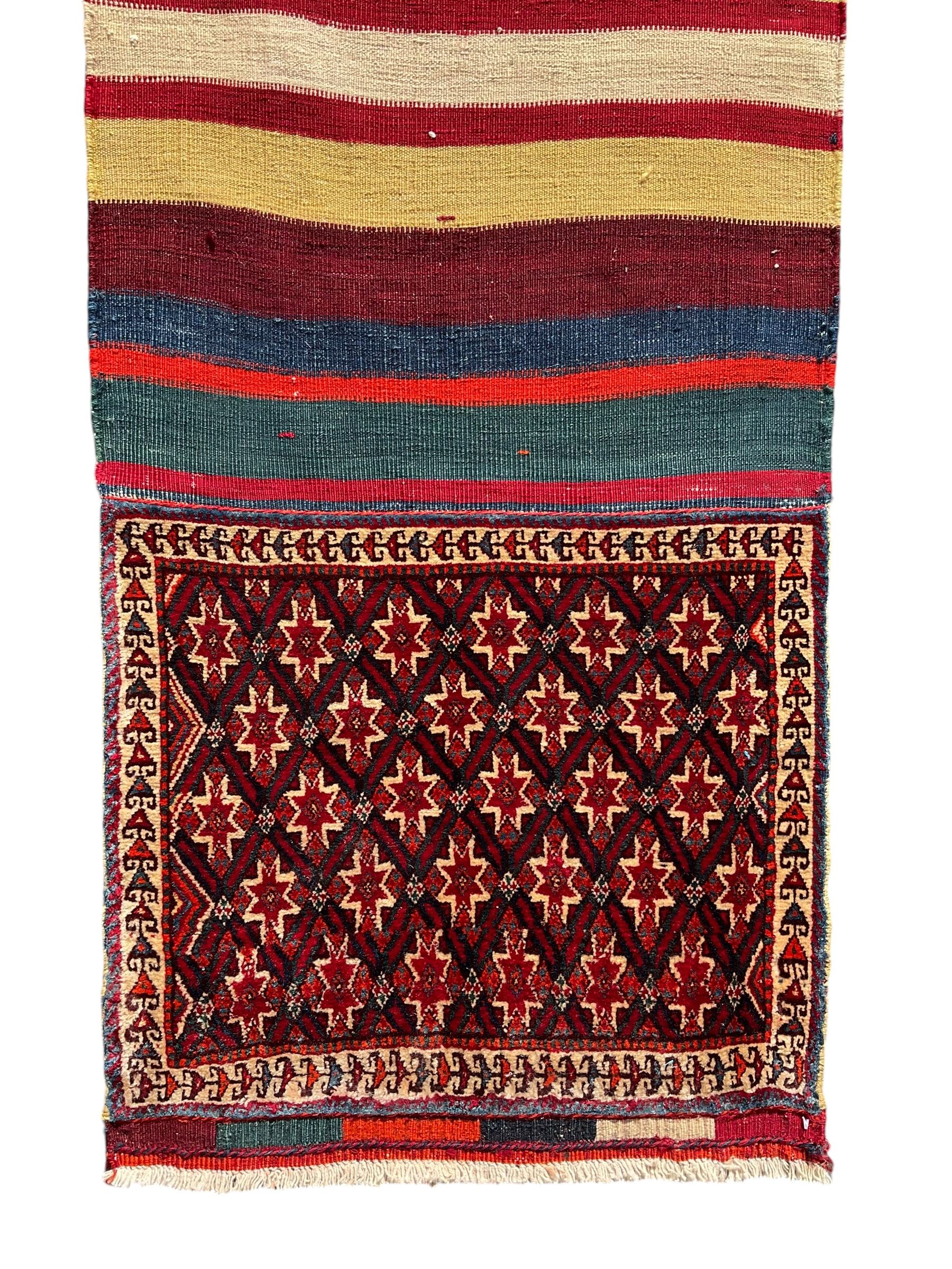 Southwest Persian Qashqai saddle bag, red and ivory ground with diamond-shaped star motifs in the top and bottom panels, central field decorated with alternating horizontal stripes