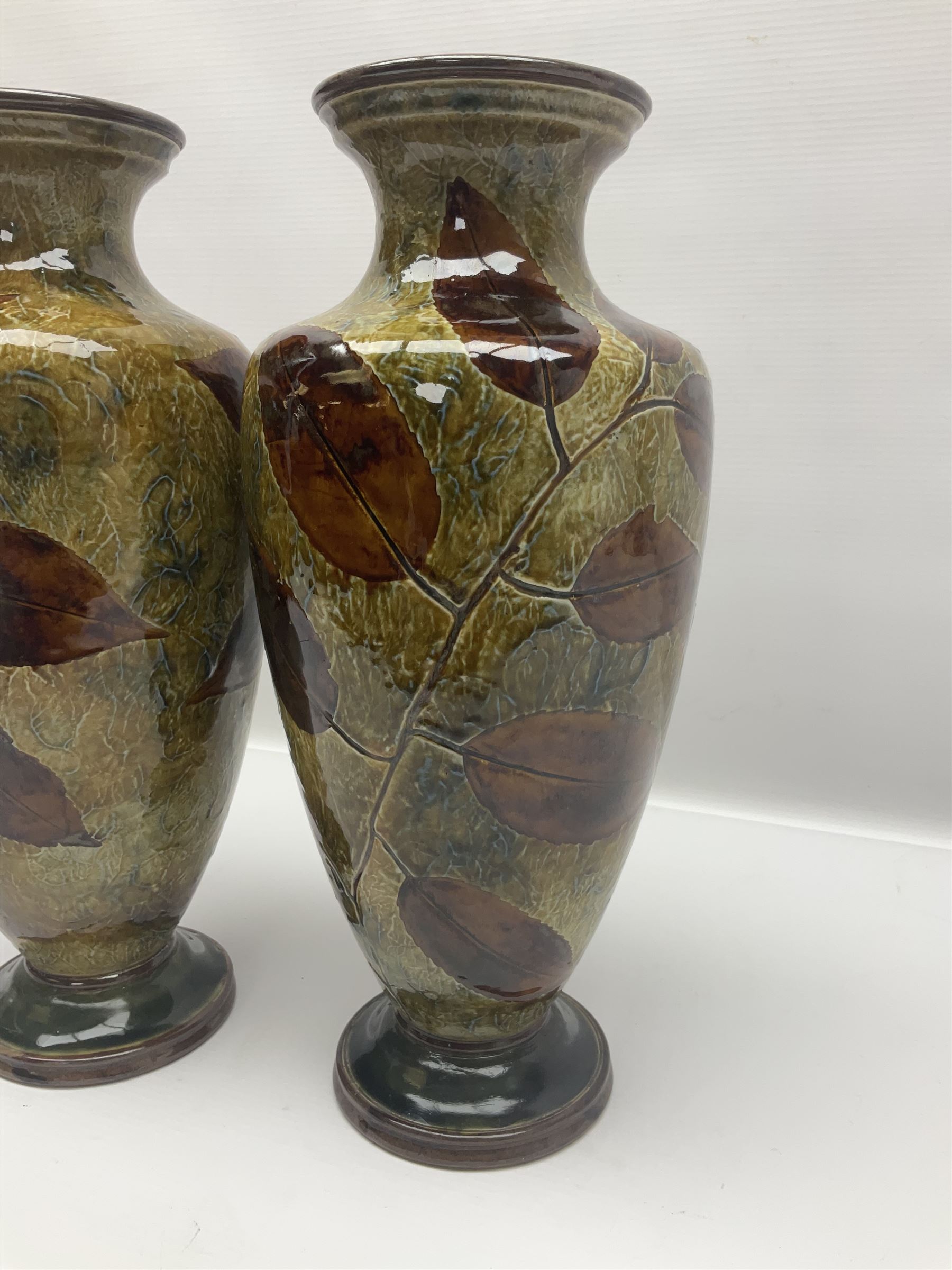 Pair of Royal Doulton Stoneware Vases with leaf decoration, by Ethel Beard, impressed marks to base numbered 6768 and 8222 and initials EB, H32cm