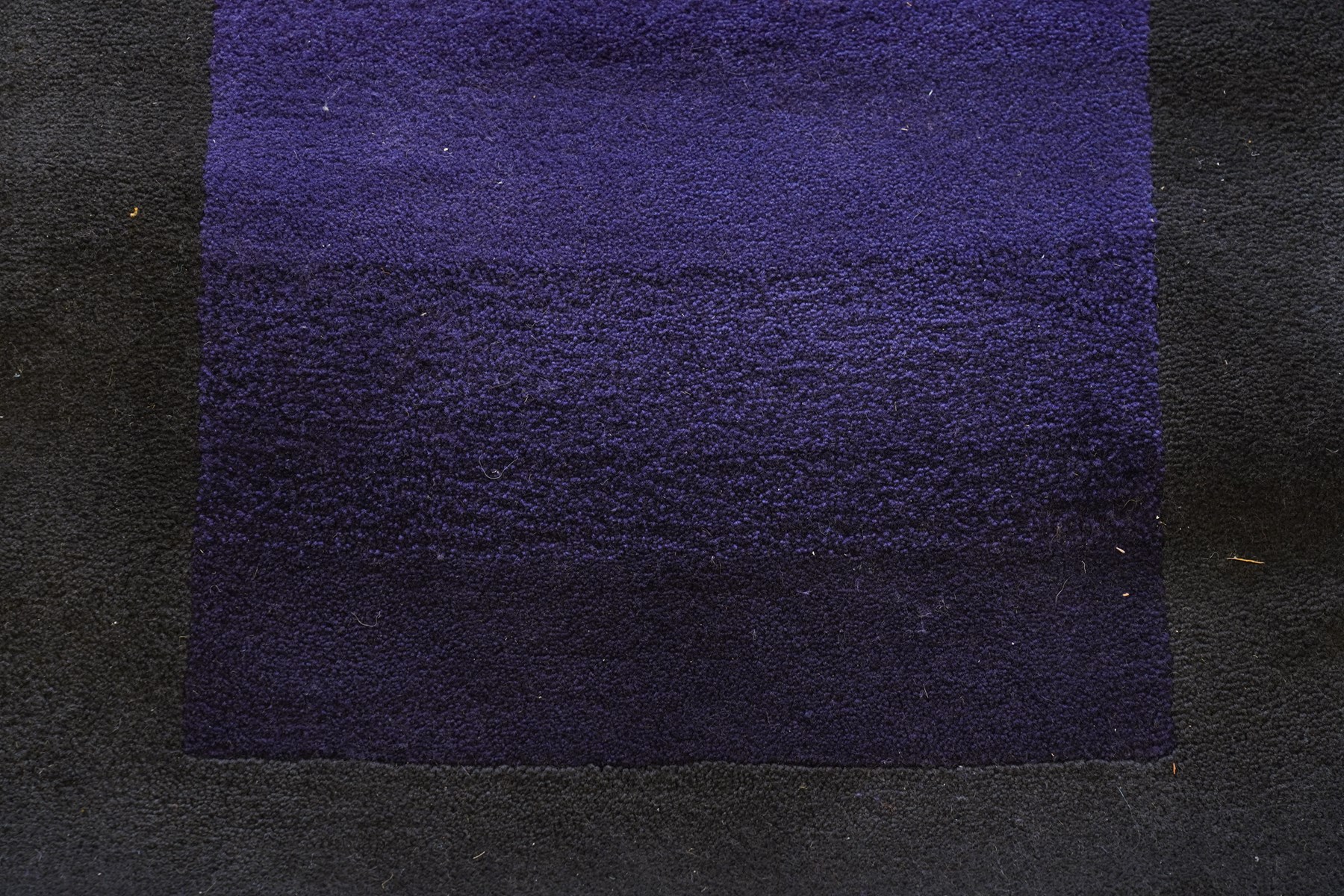 Contemporary wool runner rug, the field in a vibrant vibrant sunset-to-purple gradient with a wide dark indigo guard band