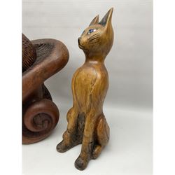 Helen Skelton (British 1933 – 2023): Three carved wooden abstract sculptures, each modelled as a cat, with carved or painted features, largest H63cm. Born into an RAF family in 1933 in Kent and travelled the world extensively during her childhood. After settling in Bridlington, Helen immersed herself in painting, textiles, and wood sculpture, often inspired by nature's beauty. Her talent was showcased in a one-woman show at Sewerby Hall and recognised with the sculpture prize at Ferens Art Gallery in 2000. Sadly, Helen’s daughter passed away from cancer in 2005. This loss inspired Helen to donate her sculptures to Marie Curie upon her passing in 2023.