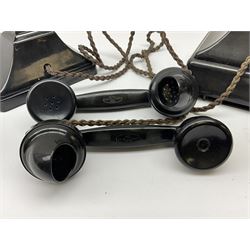 Two black Bakelite telephones of pyramid form with rotary dials, comprising The Telephone Demonstration Set model. 6al with base drawer and light bulb, and another larger with G.P.O FWR 58/2 stamped marks beneath, largest H18cm W20cm D16cm