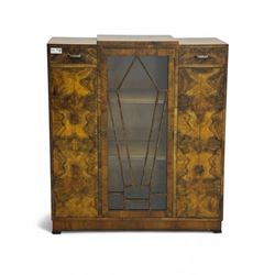 Art Deco burr walnut drinks cabinet, geometric central glazed astragal door enclosing two ...