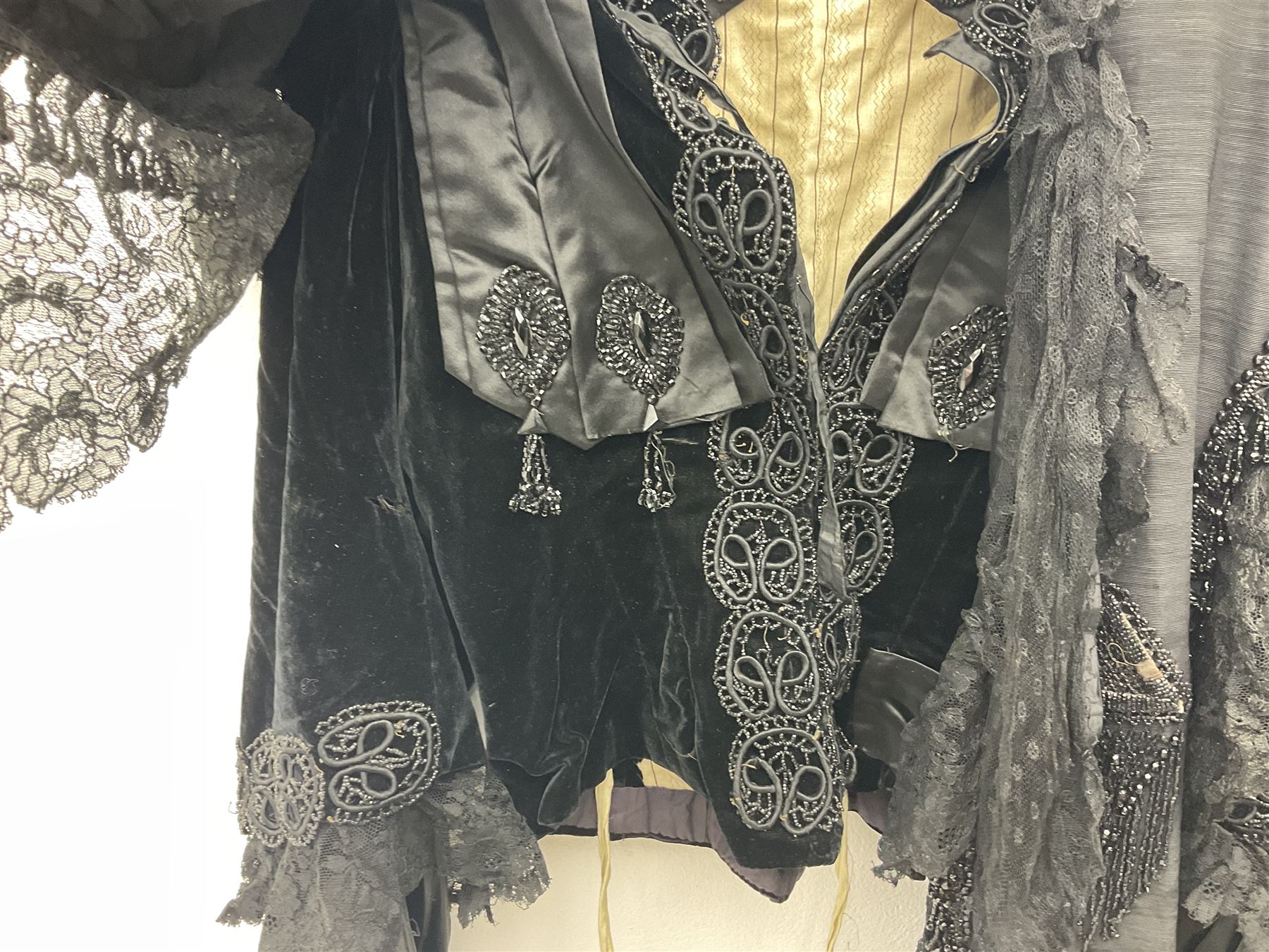 Victorian three piece mourning dress, with lace trim and jet beading, including velvet coat with satin collar panels and cuffs, the nipped waist with boning and slight flared peplum, heavily embellished beaded high neck collar, and ladies embroidered silk lined purse with gilt handle, mount and clasp