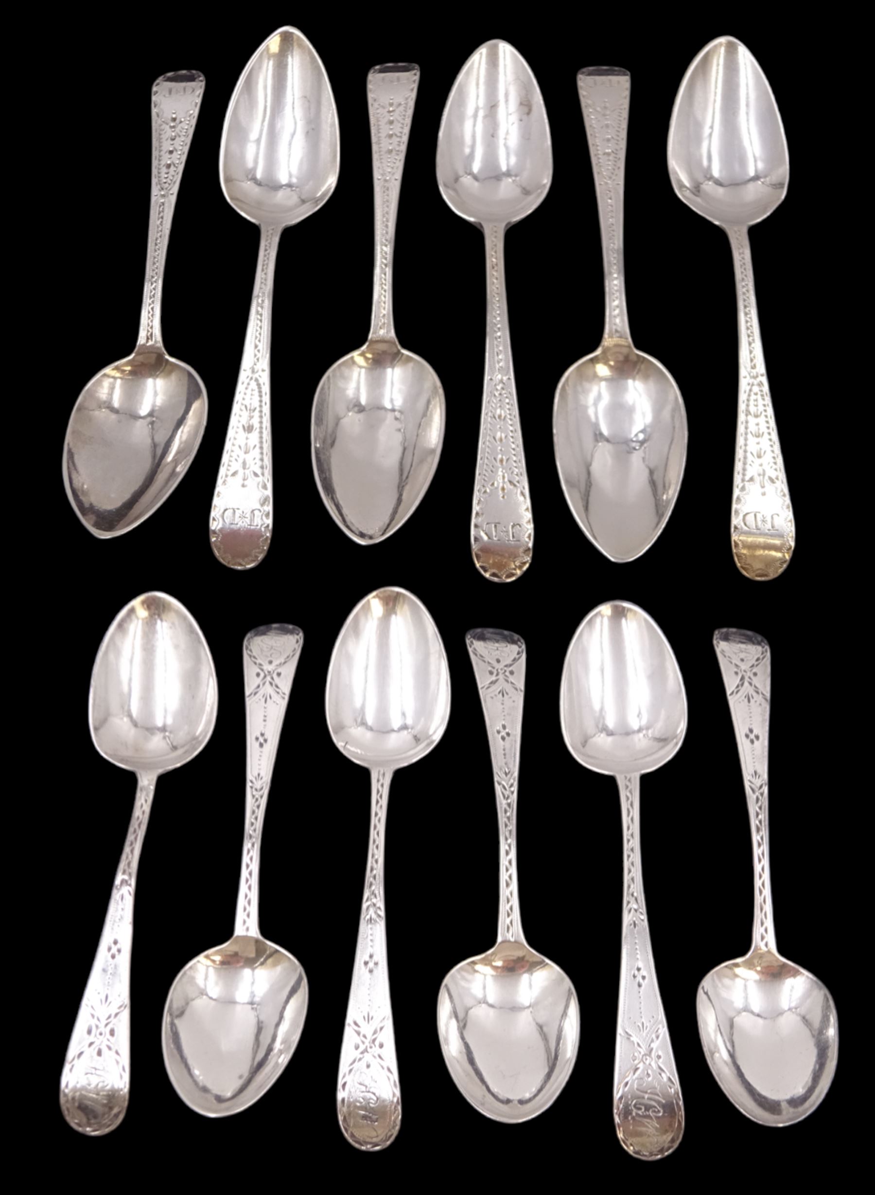 Two sets of six George III silver teaspoons, both with bright cut decoration and engraved initials, the first set hallmarked John Lambe, London 1785 and the second set hallmarked Duncan Urquhart & Naphtali Hart, London 1805