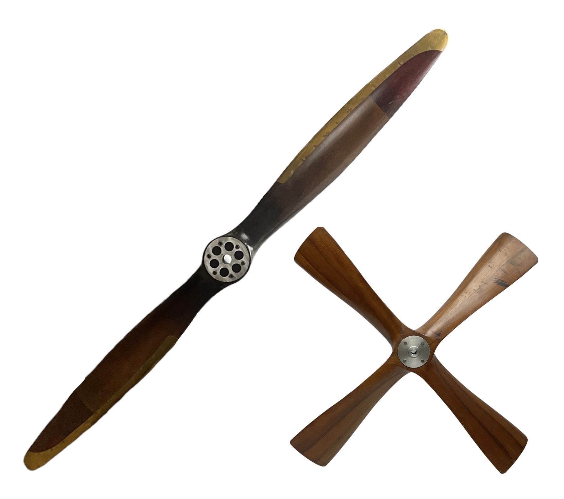 British World War II era laminated wooden four-bladed generator propeller, late 1930s-40s, used to power a drogue winch used by a target tug aircraft; marked with DRG drawing number T29505-2-4 N760 on the hub and impressed circle mark 'P.M.P.W. 1'; light weight four plank mahogany laminate with 9.5cm diameter metal plates mounted to front and rear faces of hub for 15mm shaft; one plate marked T29504-2/198 D91cm; together with a modern reproduction brass edged mahogany two-blade propellor L