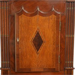 Mid 19th century- 8-day oak and mahogany longcase clock, with a carved swan necked pediment and crossbanding, break-arch hood door flanked by reeded pilasters, broad trunk with matching pilasters to the sides, short triple spire door with inlay and a and raised panel beneath, plinth with a conforming inlaid panel to the front, raised on backet feet, painted dial with floral spandrels and a rolling moon to the arch, broad Roman numerals, seconds dial, date aperture and stamped brass hands, dial pinned to a rack striking weight driven movement striking the hours on a bell. With weights and pendulum.