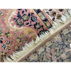 Large Persian design peach ground carpet, the field decorated with floral medallion, multi-band border decorated with repeating flower head pattern