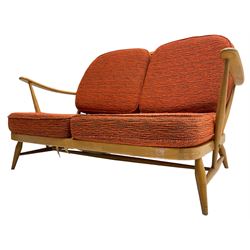 Ercol - circa. 1960s 'Windsor' two-seat Windsor settee, original covers with replaced cushions, requires re-strapped 