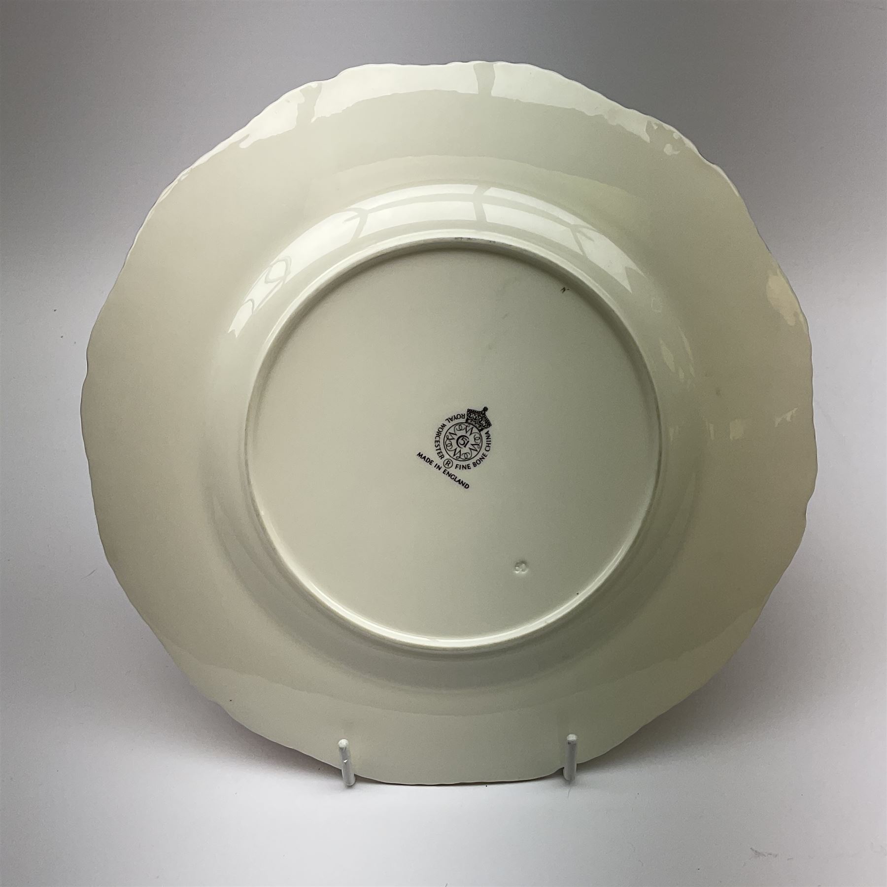 A Royal Worcester fruit painted cabinet plate, hand painted with apples and grapes against a mossy ground, signed S Weston, black printed mark beneath, D27cm