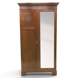 Quality Edwardian mahogany double wardrobe, featuring bevelled mirrored and panelled door with applied moulded detail, internal brass rail hanging and shoe rails