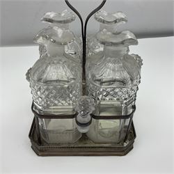 19th century Sheffield silver plated decanter stand, the square base with pierced gallery housing four cut glass decanters and stoppers, with central carrying handle, H27cm