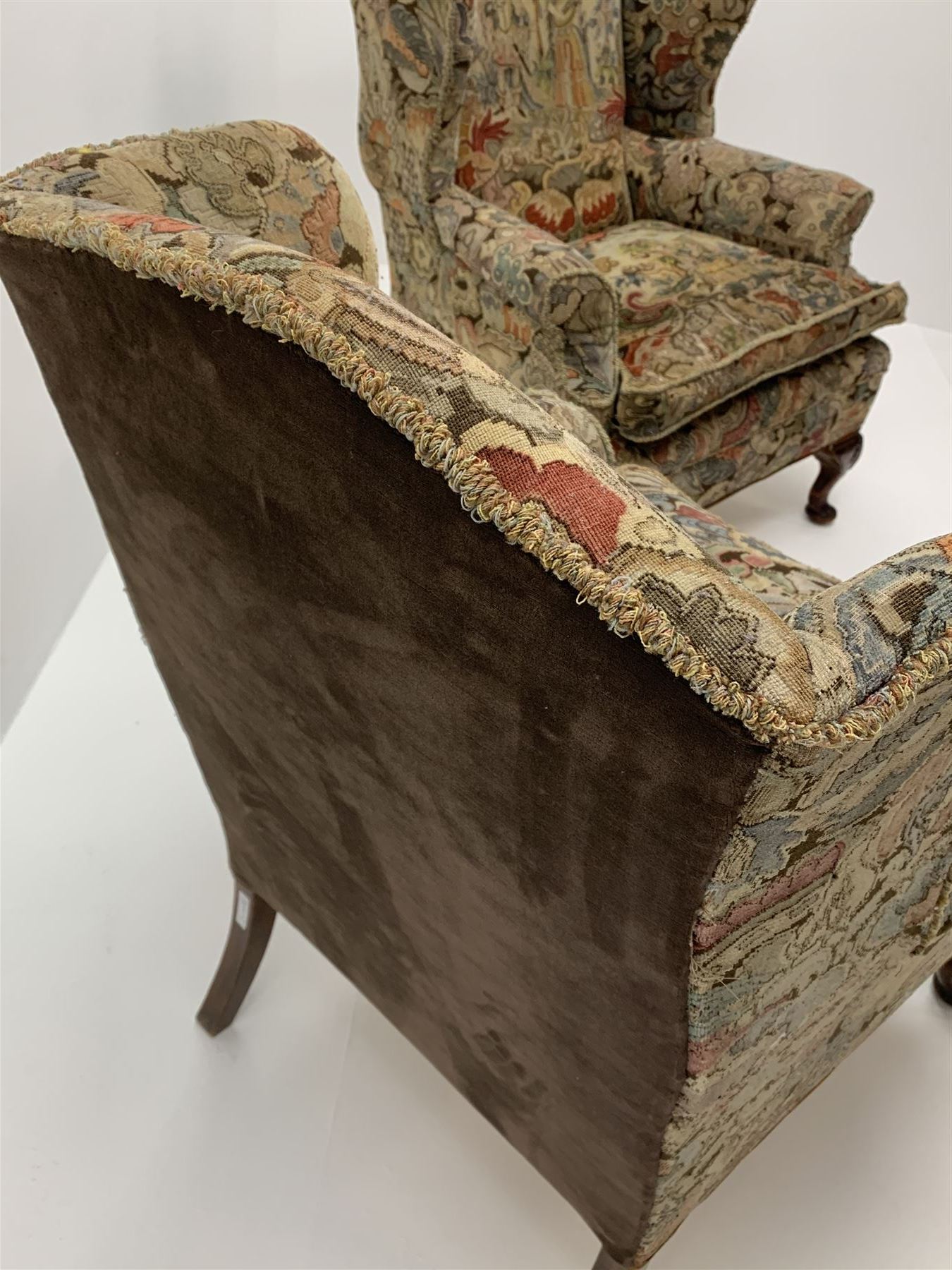 Matched pair early 20th century Queen Anne style wingback armchairs, walnut framed, sprung seats with seat cushions upholstered in needle work cover, shell carved cabriole front feet