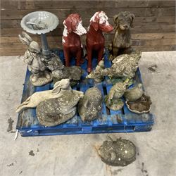 Various cast stone and composite garden ornaments, to include Peter Rabbit, goose, pigs, dogs, dog with wheelbarrow, painted metal bird bath and other, on two pallets