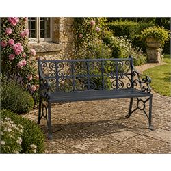 Regency period wrought iron garden bench, hand forged in wrought iron and finished in matt black paint, decorated with intricate scrollwork and featuring circular geometric ends, strapwork seat