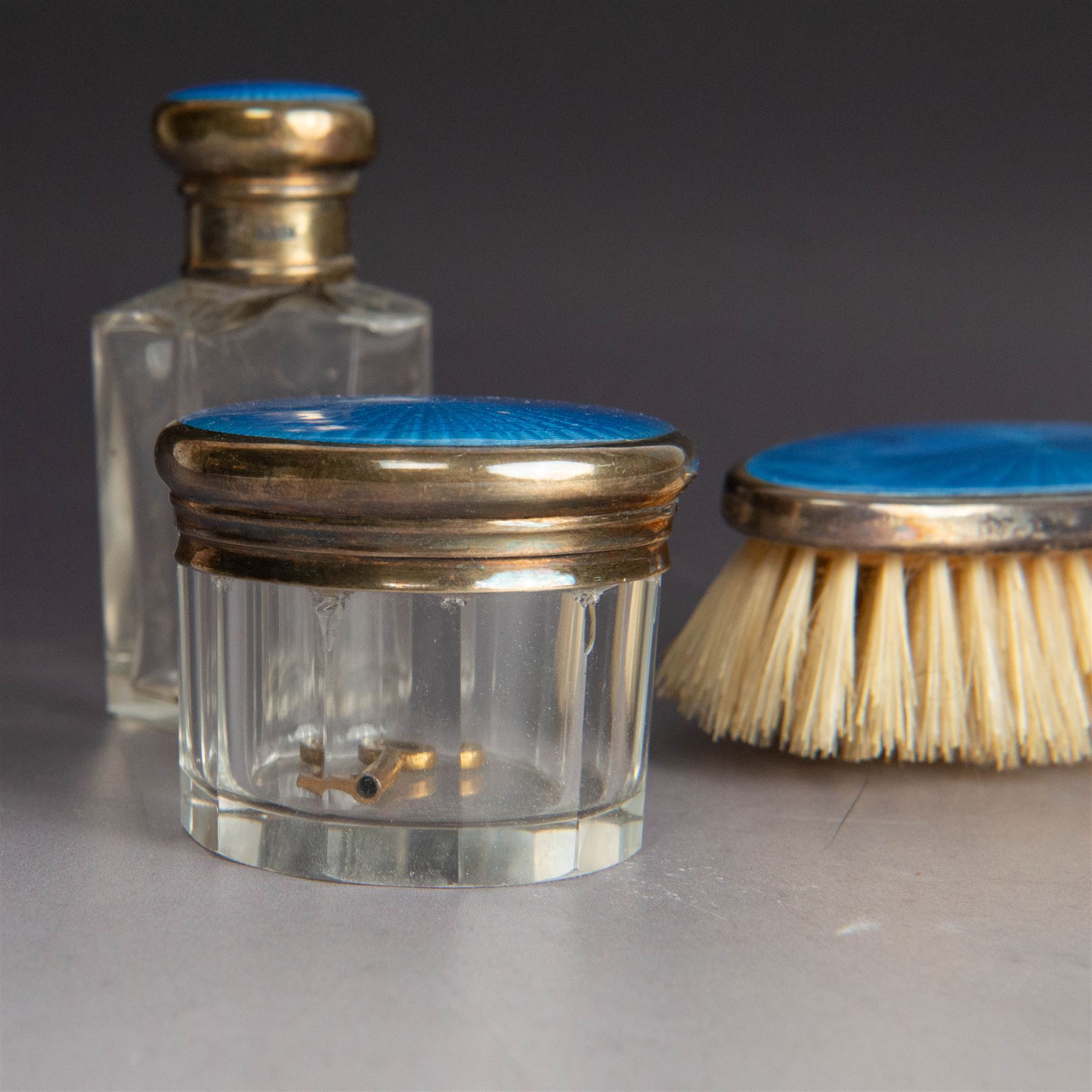 1920s silver mounted blue guilloche enamel travelling dressing table set, comprising hairbrush, comb, bottle and jar, hallmarked RWF Ltd, Birmingham 1927, contained withing tooled leather fitted case with bevelled mirror to interior