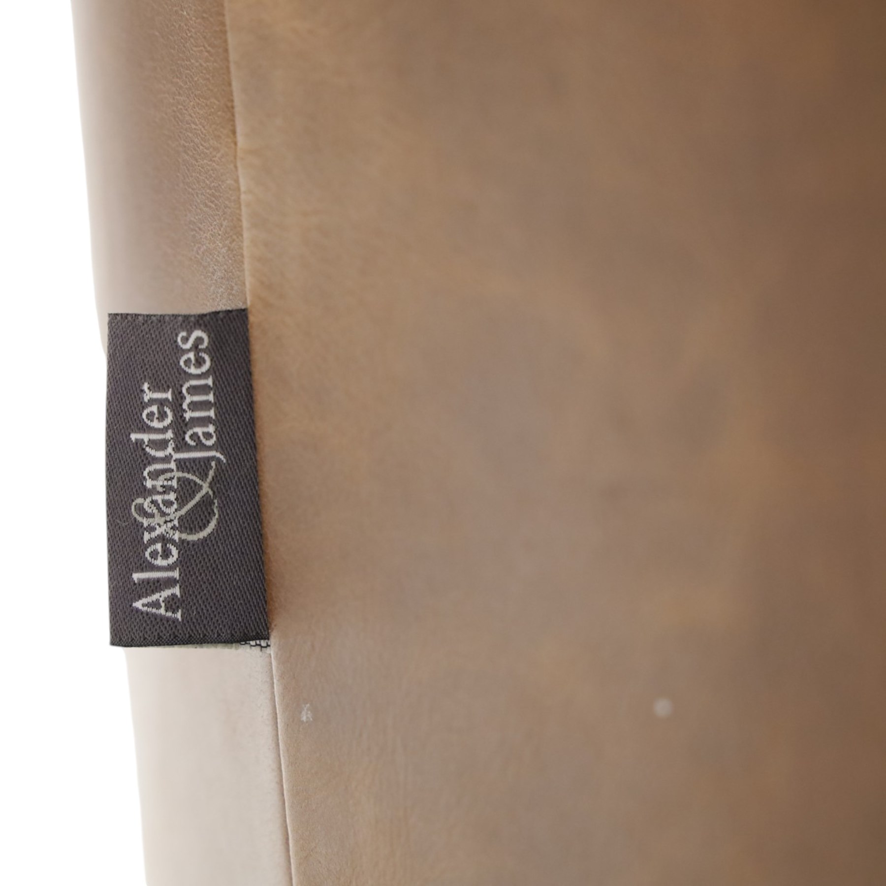Alexander and James - pair of 'Jude' tub armchairs, traditional tub shape with buttoned back over deep seat, with studwork to the arm terminals, raised on turned front supports and splayed rear supports