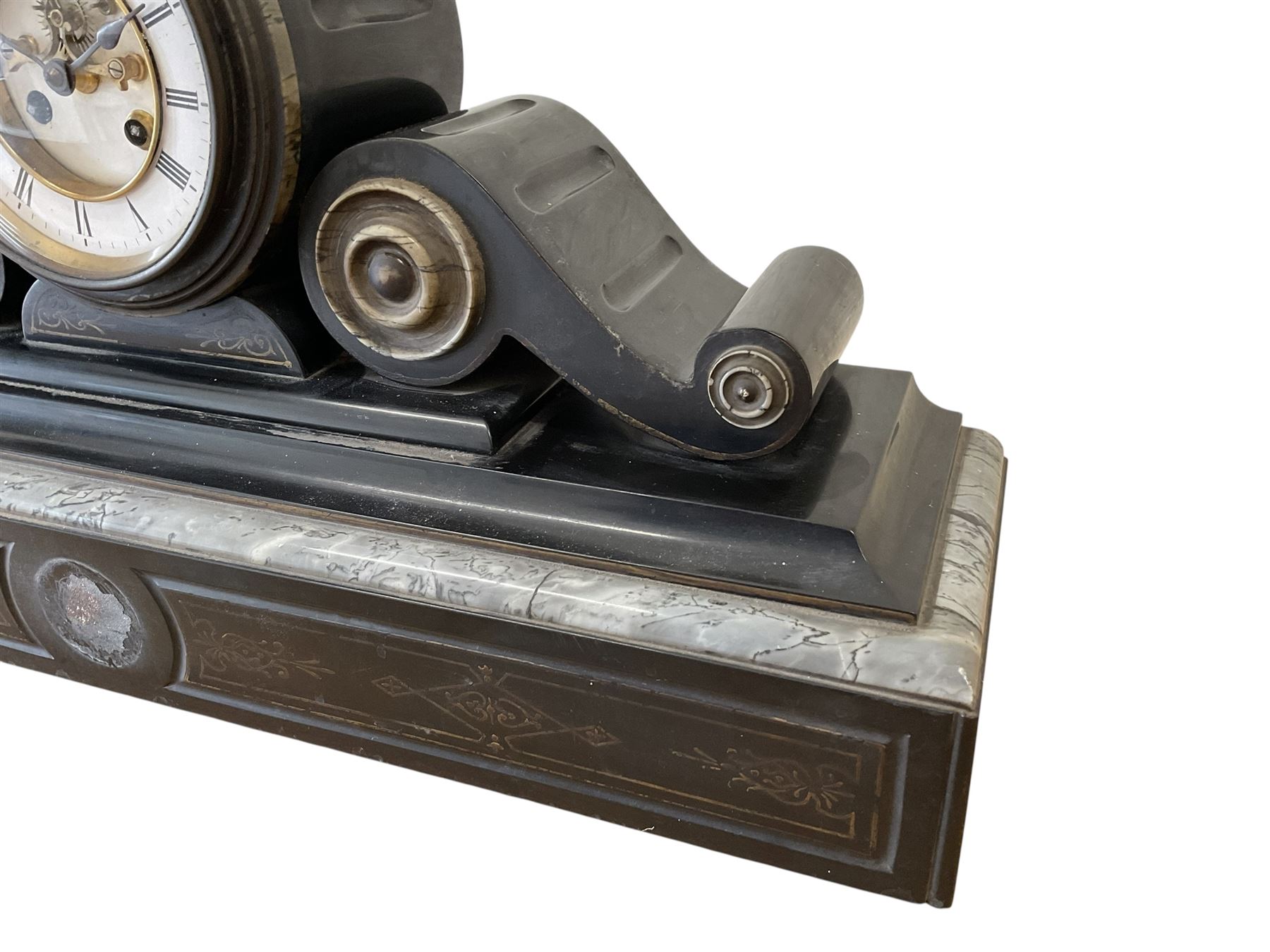 French- late 19th century 8-day Belgium slate and marble mantle clock, drum movement with volutes and conforming scroll side pieces, on a stepped plinth with incised decoration to the front, two-piece enamel dial with a visible Brocot deadbeat escapement, spade hands and Roman numerals, twin train, countwheel striking movement, sounding the hours and half-hours on a bell. With pendulum and key. 