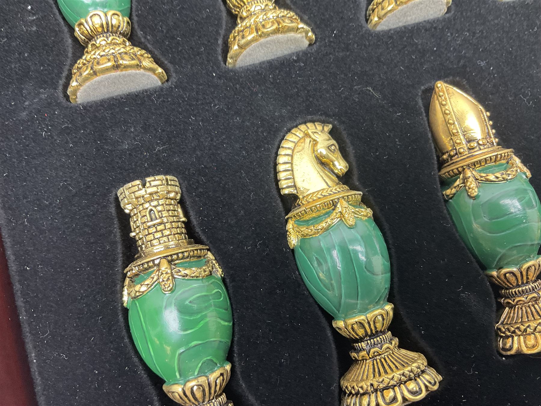 Franklin Mint House of Faberge 'The Imperial Jewelled Chess Set', to include set of chess pieces with malachite finish and a set with carnelian finish and a hardwood chess board