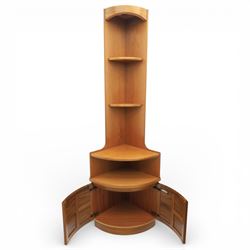 Nathan - teak corner cabinet, the upper section with moulded cornice and two fixed shaped open shelves, above a curved corner cupboard with twin signature square panelled doors, on a shaped plinth
