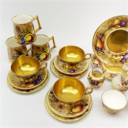 A selection of Aynsley fruit decorated teawares, comprising three large teacups and saucers, three smaller teacups and saucers, five side plates, two larger plates, an open sucrier, milk jug, and two vases, signed D Jones and N Brunt, together with five Baron China mugs with similar fruit decoration, and a small Worcester Locke & Co vase decorated with a robin perched upon a blossoming branch (a/f), all items with marks beneath. 