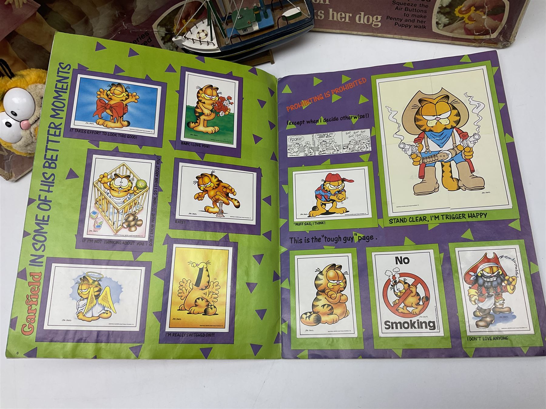 Two boxed Bradgate Penny Puppywalker dolls; Garfield soft toy and Panini sticker album; boxed Stylophone with instructional 45rpm record; and other toys