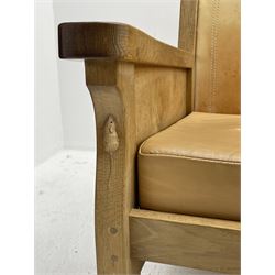 'Mouseman' oak smokers armchair, panelled sides, slung tan leather back and upholstered seat cushion, by Robert Thompson of Kilburn