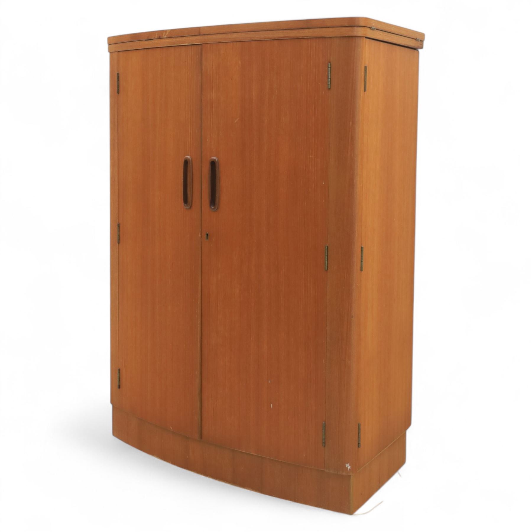 Turnbridge of London - Mid 20th century teak cocktail cabinet, with fold out top extending to 160cm, with twin doors revealing a shelved interior, the back with sliding glazed doors, raised on a recessed plinth base with castors