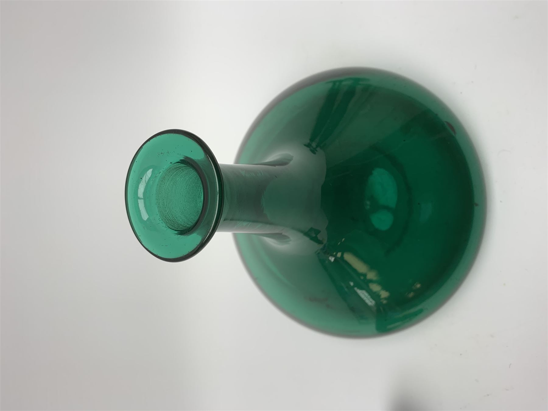 19th century green glass ships decanter with flat topped stopper, H21.5cm, together with a set of four 19th century green glass wine glasses, the funnel bowls upon bladed knopped stems and circular feet, H13cm