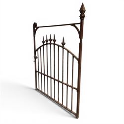 Georgian wrought iron single garden gate, pointed finial over strapwork cresting rail and arched profile with spearhead finials, the opposing side with scrollwork and hinged latch