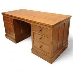 Mouseman - oak pedestal kneehole desk, adzed rectangular top over twin pedestals each fitted with three drawers, arched kneehole with panelled interior, on plinth base, signature carved mouse to side, by the workshop of Robert Thompson, Kilburn