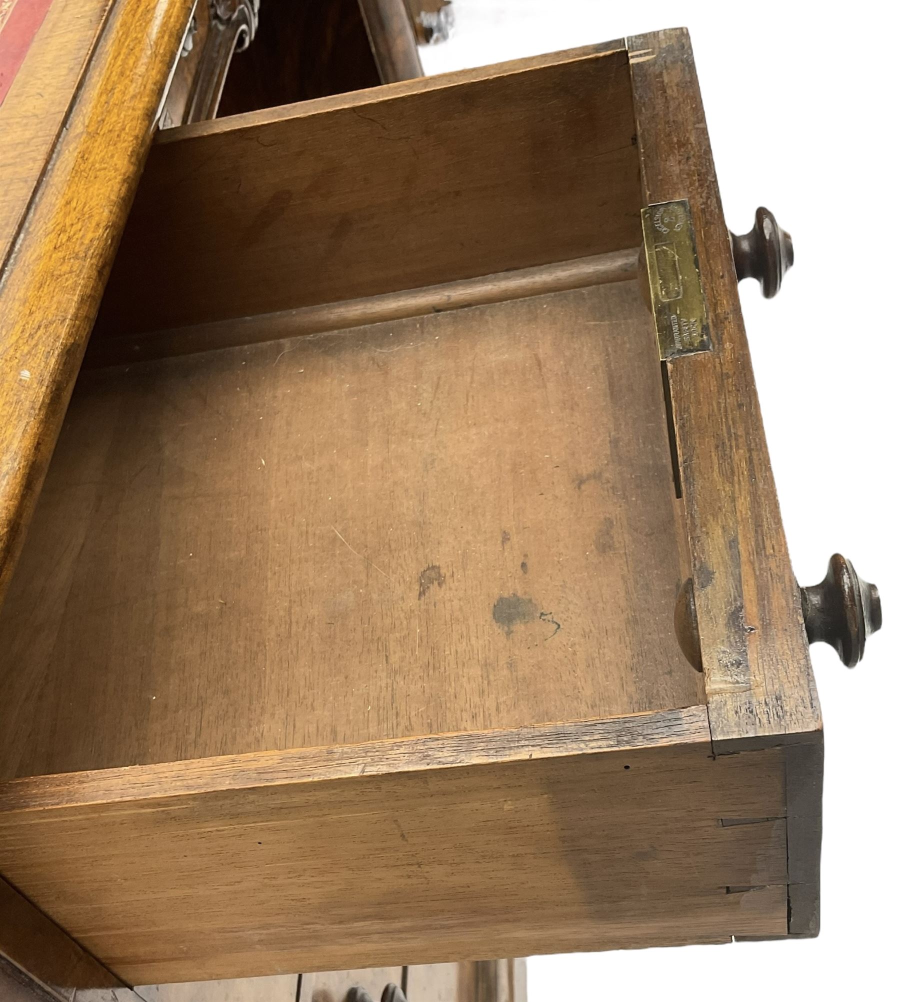 Victorian figured walnut kneehole desk, moulded rectangular top with inset leather writing surface, fitted with nine drawers, the central frieze drawer with carved curled foliage mount, on moulded plinth base,