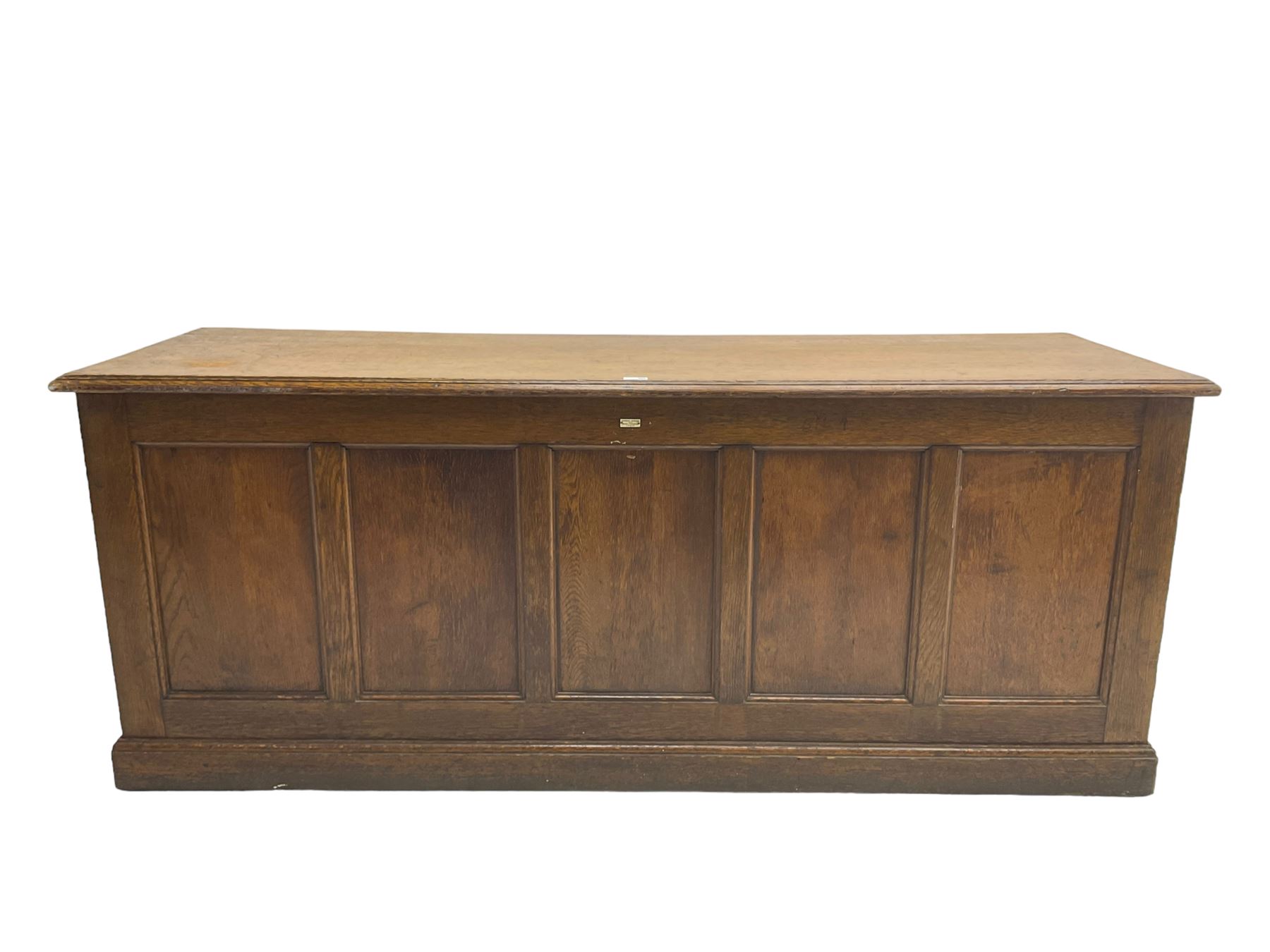 Illingworth Ingham and Co. School Furnishers (Leeds c1900) - early 20th century oak rostrum or headmaster's desk, rectangular top, the front and sides panelled with open reverse, on plinth base
