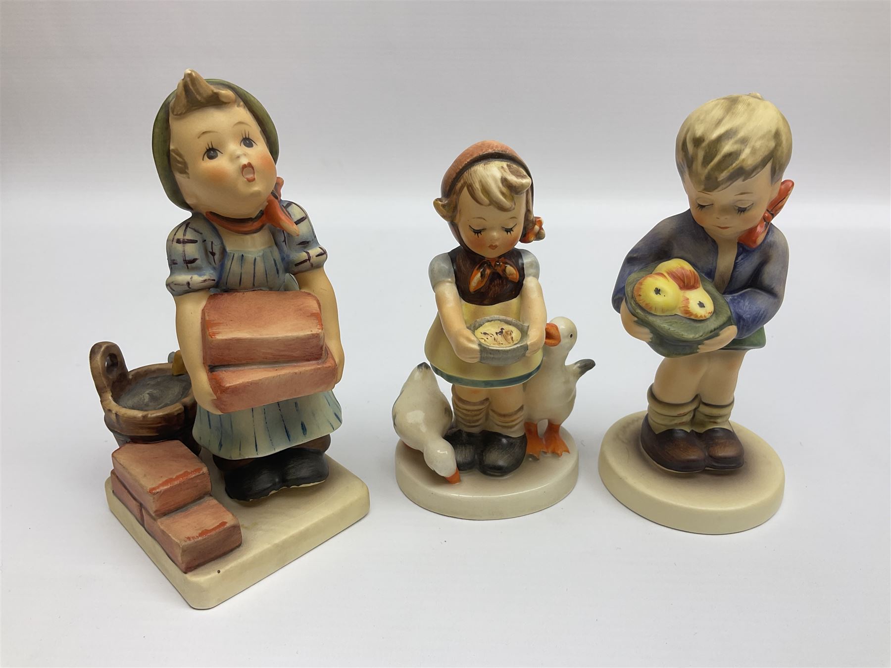 Twenty five Hummel figures by Goebel, to include Tuning up, Blessed Event, Book Worm, The Little Architect etc 