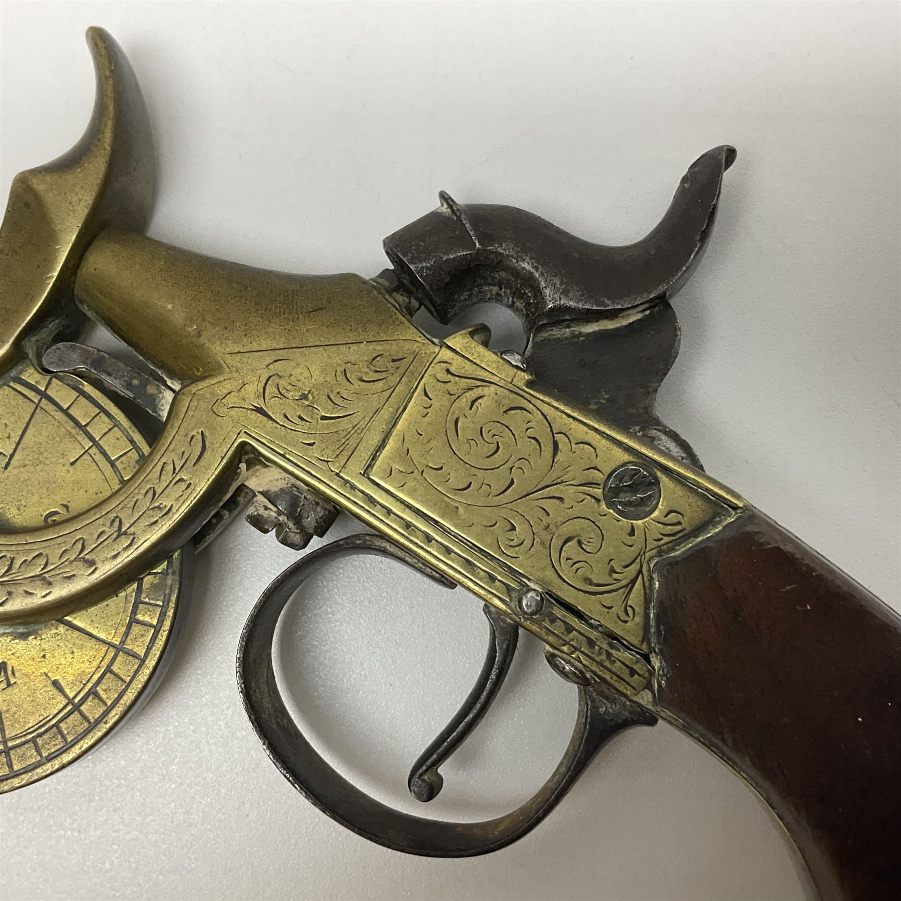 19th Century percussion eprouvette or gunpowder tester, with foliate engraved brass box lock and calibrated ratcheted wheel, steel trigger guard and walnut bag butt, L14cm