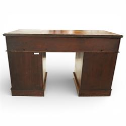 Late Victorian oak nine drawer desk, the rectangular top inset with a tooled leather writing surface bordered in gilt, above three frieze drawers and two pedestal cupboards each fitted with three graduated drawers, all with brass swan neck handles, raised on plinth bases