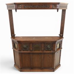 Old Charm - carved oak bar with three bar stools and associated Old Charm drinks cabinet, carved top with channels for glassware beneath, bar surface above glazed panels, shelves for glassware to the back, associated Old Charm drinks cabinet with fall front linenfold carving, above twin doors with shelved interior