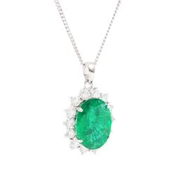 18ct white gold emerald and diamond pendant necklace, single oval cut  emerald of approx 3.25 carat, surrounded by fourteen round brilliant cut diamonds, on a fine link chain necklace, hallmarked, total diamond weight approx 0.50 carat