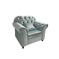 Chesterfield shaped armchair, upholstered in buttoned light blue fabric, with scatter cushions