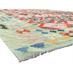 Kilim pastel ground rug, the field decorated with repeating multicoloured geometric diamond motifs, enclosed within matching geometric borders