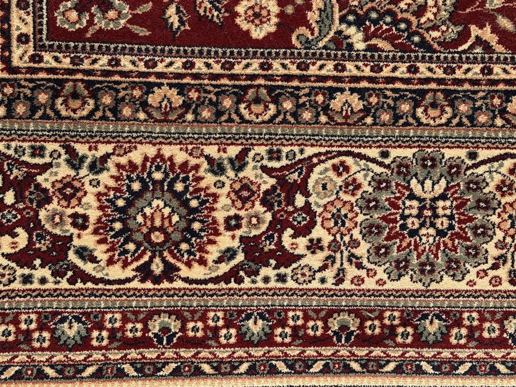 Royal Kashmir worsted wool modern Persian design area rug, with crimson field and stylised rosette patterning throughout, surrounded by wide multi-band border incorporating cartouche and lotus flower motifs