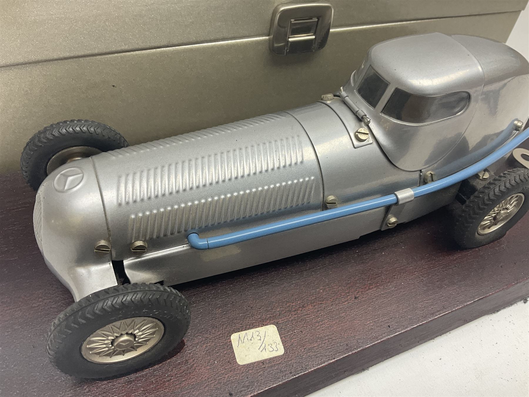 Marklin tin-plate clockwork Mercedes-Benz W25 racing car with driver in hinged cockpit model no.1096; fitted on mahogany base L33cm; in original metallic silver box with key