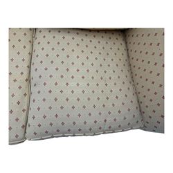 20th century Knole design two seat sofa, high back and double drop-arm joined by mahogany finials and ties, upholstered in camel ground fabric with red lozenge design, on turned supports with brass castors