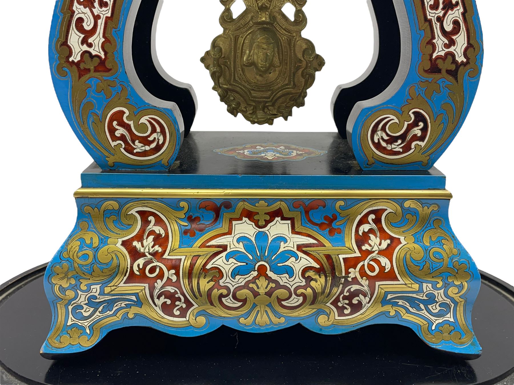 Breguet A Paris - Mid-19th century 8-day French portico clock, ebonised case with brass and cloisonne inlay, on a rectangular plinth with a shaped base, white enamel dial with blue Roman numerals, minute track and steel trefoil hands, cast brass bezel with scroll and foliate decoration and a conforming gridiron pendulum, twin train going barrel movement with a countwheel strike sounding the hours and half-hours on a bell, with an ebonised base and glass dome. 