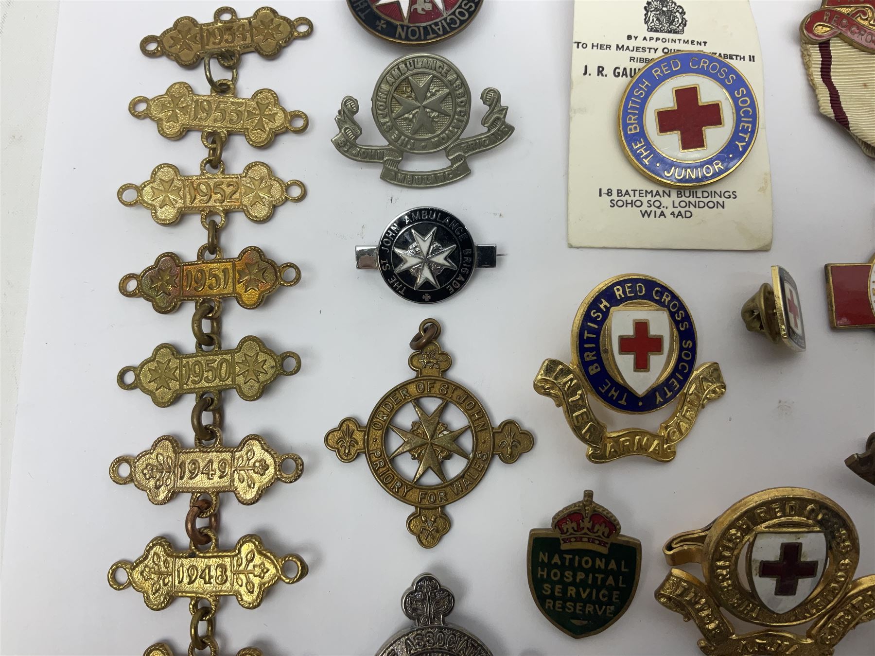 Collection of St John Ambulance enamel and metal badges, together with Red Cross medals and badges