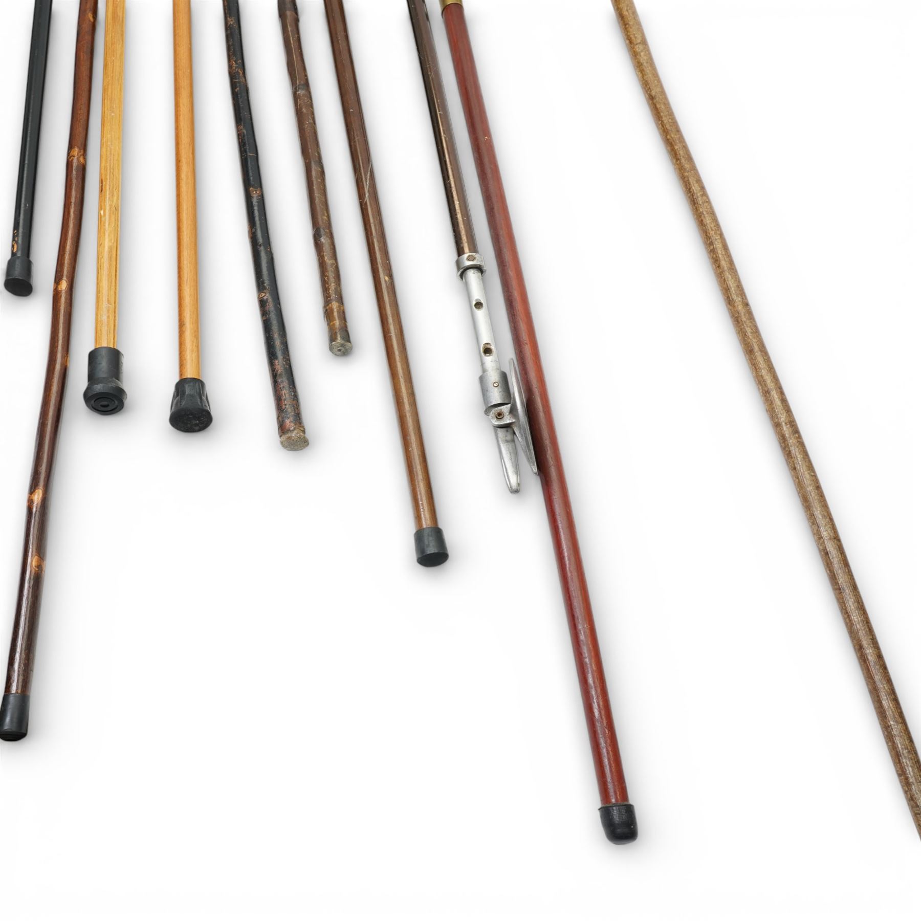 Collection of modern walking sticks, ebonised evening canes, thumb stick and shooting stick etc 
