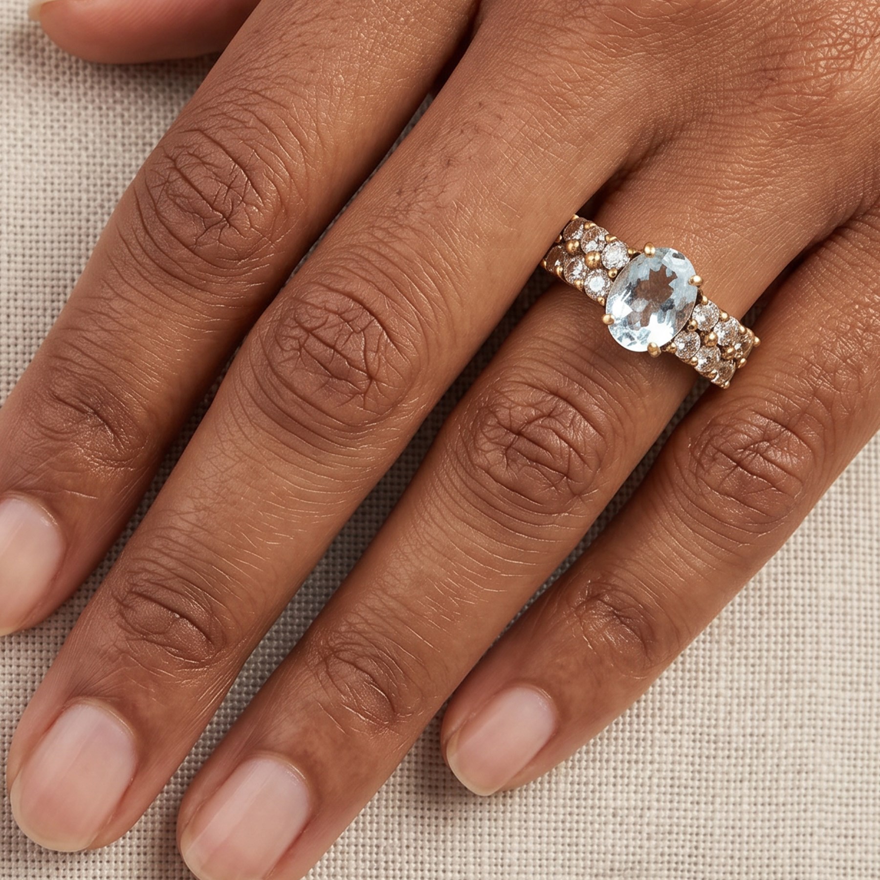 9ct gold aquamarine and blue topaz ring, single oval cut aquamarine, with two rows of round cut topaz's set either side, hallmarked
