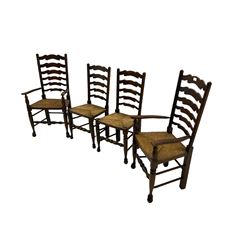 Set of four quality elm ladder back dining chairs, comprising two carver armchairs and two side chairs, with rush seats