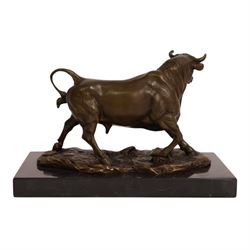 After Antoine-Louis Barye: bull upon naturalistic base, bronze, signed A Barye and bearing foundry mark, upon rectangular black stone plinth, overall H14cm L21cm