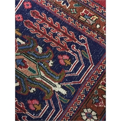 Kashan red ground rug carpet, the field decorated with scrolling stylised foliage with central medallion, repeating blur ground border with flower head guard, 390cm x 295cm