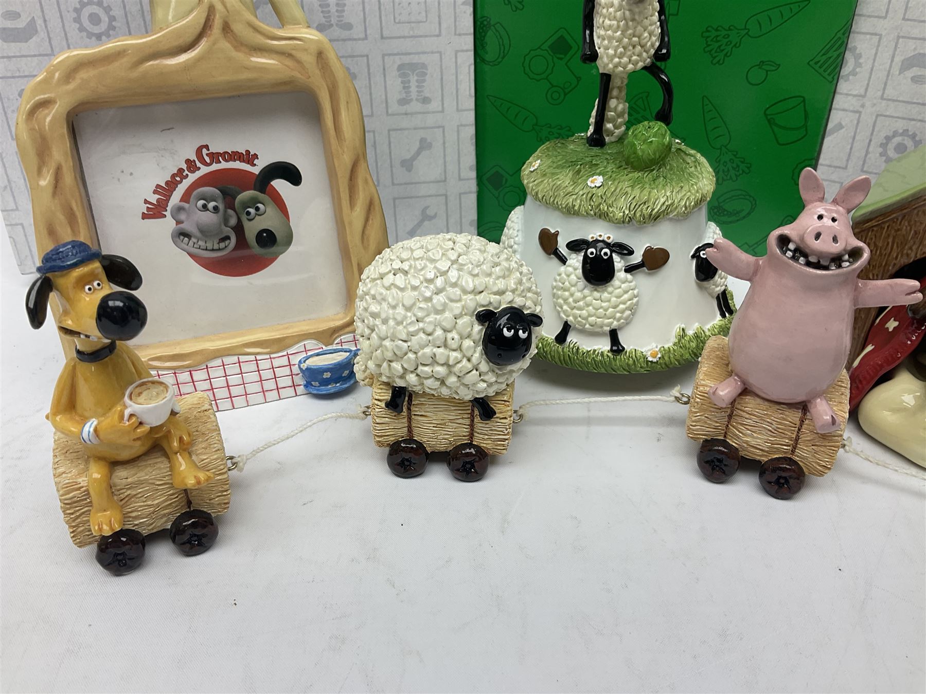 Border Fine Arts Shaun The Sheep Tractor Train and musical figure, together with a Wallace and Gromit photograph frame and a Gromit cruet sett, three in original boxes  
